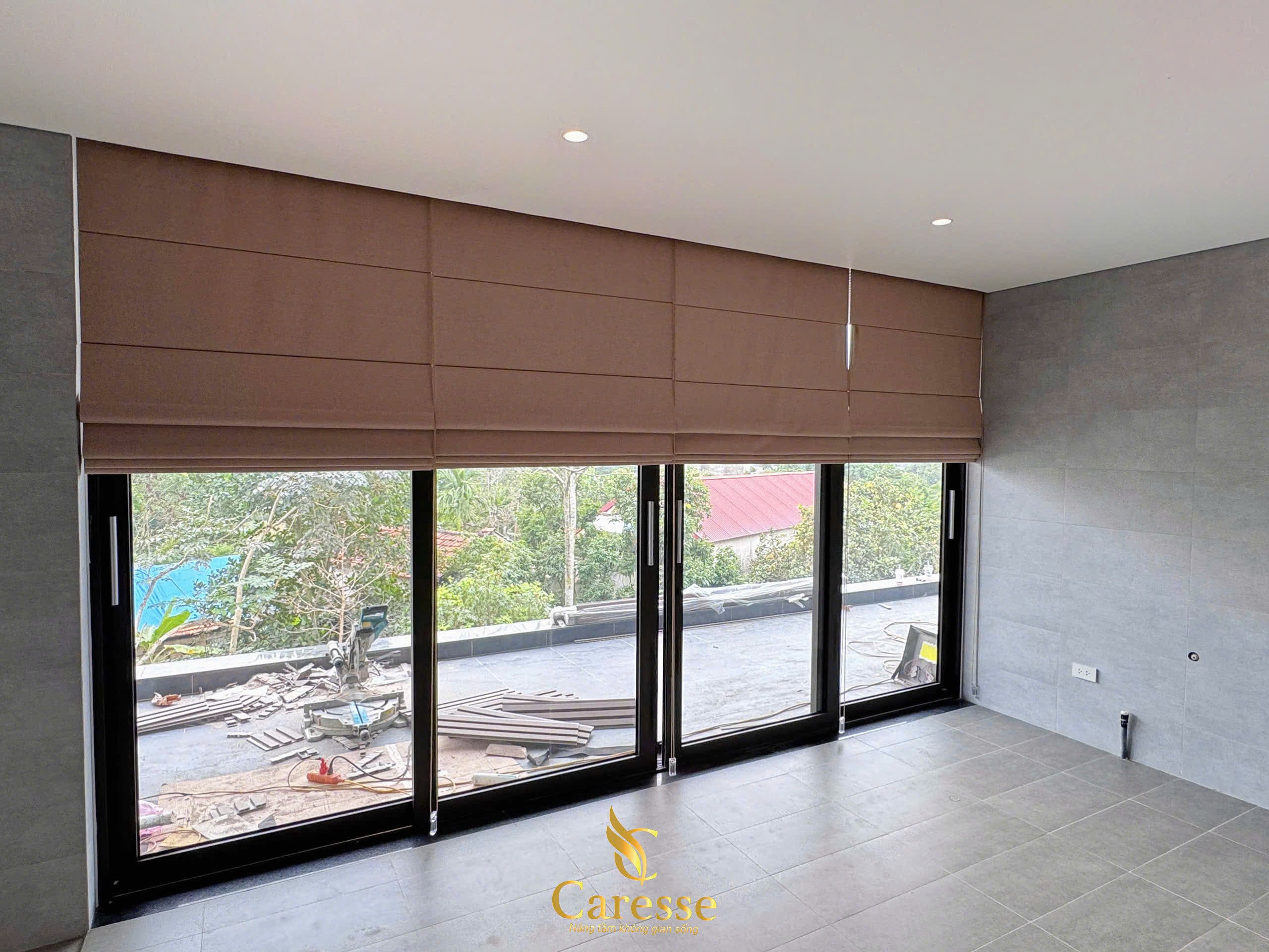 Rèm xếp lớp màu nâu tại cửa kính rộng